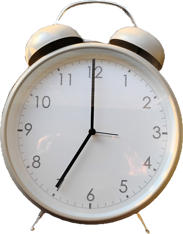 A beige twin-bell alarm clock