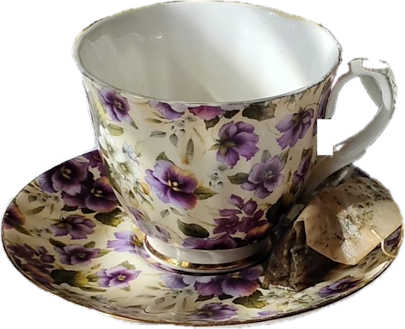 A floral china teacup and saucer with a tea bag